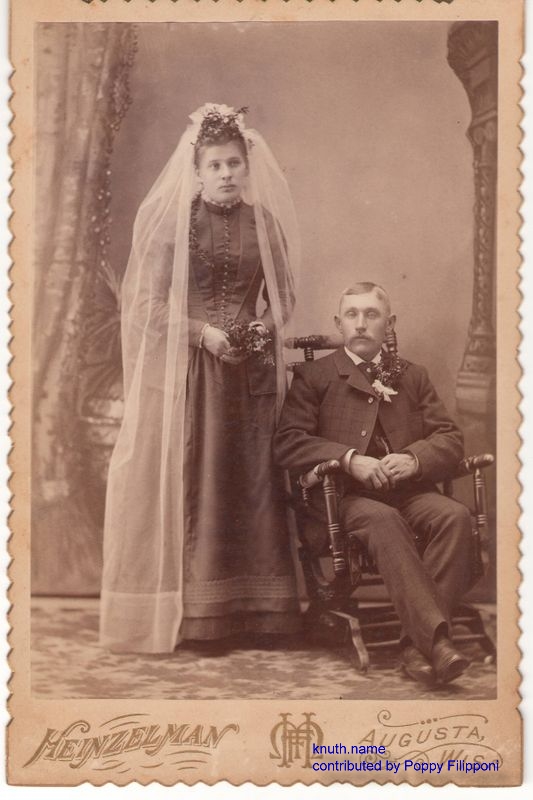 Formal Wedding Portait of seated Man and Standing Wife
